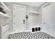 Stylish mud room with patterned tile, storage shelves, and convenient bench seating at 3910 Reed St, Wheat Ridge, CO 80033
