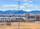 Property overlooks athletic field and offers stunning views of snow-capped mountains at 3910 Reed St, Wheat Ridge, CO 80033