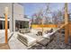 A modern outdoor patio with a fire pit, comfortable seating, and string lights for evening ambiance at 3910 Reed St, Wheat Ridge, CO 80033