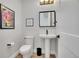 Clean powder room with modern fixtures, decorative art, and stylish mirror at 3910 Reed St, Wheat Ridge, CO 80033