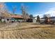 This spacious backyard offers a playset, shed, and patio for fun, storage, and relaxation at 7770 S Estes St, Littleton, CO 80128