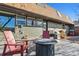 Relax on the patio with a fire pit, grill, and chairs, perfect for outdoor gatherings and enjoyment at 7770 S Estes St, Littleton, CO 80128