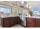 Well-lit bar in a kitchen with warm wood cabinets and stainless steel appliances at 7770 S Estes St, Littleton, CO 80128