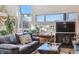 Well-lit living room featuring a fireplace, scenic views, and comfortable seating at 7770 S Estes St, Littleton, CO 80128