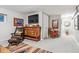 Living room with a custom cabinet, large-screen television, and Southwestern-patterned rug at 7770 S Estes St, Littleton, CO 80128