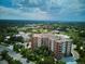 Breathtaking aerial view of the building set against a backdrop of scenic greenery and skyline at 4875 S Monaco St # 303, Denver, CO 80237