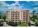 Aerial view of a condo building with balconies, set amidst green trees and landscaping at 4875 S Monaco St # 303, Denver, CO 80237