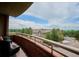 Charming balcony showcasing city views and elegant brick and wrought iron details at 4875 S Monaco St # 303, Denver, CO 80237