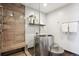 Modern bathroom featuring luxurious walk-in shower with seating and sleek metal tub at 4875 S Monaco St # 303, Denver, CO 80237