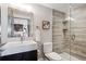 Stylish bathroom with a modern sink, sleek mirror, toilet, and glass-enclosed shower with tiled accents at 4875 S Monaco St # 303, Denver, CO 80237