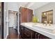 Elegant bathroom with dual sinks, modern fixtures, and a spacious walk-in closet at 4875 S Monaco St # 303, Denver, CO 80237