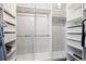 Spacious walk-in closet with ample white shelving and hanging rods, offering plenty of storage options at 4875 S Monaco St # 303, Denver, CO 80237