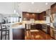 Stylish kitchen boasts stainless steel appliances and modern finishes with hardwood floors at 4875 S Monaco St # 303, Denver, CO 80237