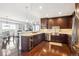 Modern kitchen featuring stainless appliances, dark wood cabinetry, and hardwood flooring at 4875 S Monaco St # 303, Denver, CO 80237