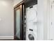 Convenient in-unit laundry area with a stacked washer and dryer behind a sliding door at 4875 S Monaco St # 303, Denver, CO 80237