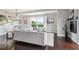 Elegant living area with hardwood floors, a chandelier, and plenty of natural light at 4875 S Monaco St # 303, Denver, CO 80237