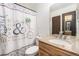 Bathroom featuring vanity sink with granite countertop, and a decorative shower curtain at 8746 Carr Loop, Arvada, CO 80005