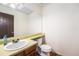 Bathroom with a single sink vanity, large mirror, and a toilet at 8746 Carr Loop, Arvada, CO 80005