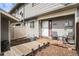 Inviting front porch with wooden deck and seating area at front entry at 8746 Carr Loop, Arvada, CO 80005
