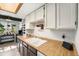 Kitchen detail showcasing butcher block countertops and white cabinets with good storage at 8746 Carr Loop, Arvada, CO 80005