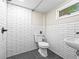 Updated bathroom features modern subway tile, sleek fixtures, and stylish design at 1987 S Downing St, Denver, CO 80210