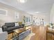 Open-concept living room with hardwood floors, neutral walls, and adjacent dining area at 1987 S Downing St, Denver, CO 80210