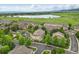 Scenic aerial view of the townhome community near a lake and green open spaces at 12919 W Burgundy Dr, Littleton, CO 80127