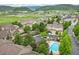 Beautiful aerial view of the community highlighting the pool, greenery, and nearby amenities at 12919 W Burgundy Dr, Littleton, CO 80127