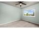 Bedroom featuring carpet, ceiling fan, and a window with natural light at 12919 W Burgundy Dr, Littleton, CO 80127