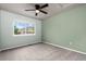 Bedroom featuring carpet, ceiling fan, and a window with outdoor views at 12919 W Burgundy Dr, Littleton, CO 80127