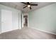 Bright bedroom featuring carpet, ceiling fan, and double door closet at 12919 W Burgundy Dr, Littleton, CO 80127