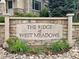 Community entrance sign reading 'The Ridge at West Meadows' in a landscaped setting at 12919 W Burgundy Dr, Littleton, CO 80127