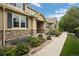 Charming home exterior featuring stone accents, and well-manicured landscaping at 12919 W Burgundy Dr, Littleton, CO 80127