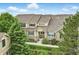 Aerial view showcasing the townhome's well-kept facade with stone accents and blue shutters at 12919 W Burgundy Dr, Littleton, CO 80127