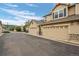 Exterior view of townhomes featuring attached garages and neutral color palettes at 12919 W Burgundy Dr, Littleton, CO 80127