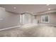 Spacious finished basement with neutral carpet, recessed lighting, and full bath at 12919 W Burgundy Dr, Littleton, CO 80127