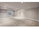 Finished basement featuring neutral carpet, recessed lighting, and egress window at 12919 W Burgundy Dr, Littleton, CO 80127