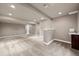 Finished basement with neutral carpet, recessed lighting, wet bar, and egress window at 12919 W Burgundy Dr, Littleton, CO 80127