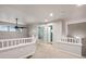 Upstairs hallway featuring carpet, white railing, and access to the bedrooms at 12919 W Burgundy Dr, Littleton, CO 80127