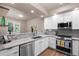 Bright kitchen features white cabinets, stainless steel appliances, and granite countertops at 12919 W Burgundy Dr, Littleton, CO 80127