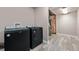 Convenient laundry room featuring gray floors and included washer and dryer at 12919 W Burgundy Dr, Littleton, CO 80127