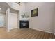 This is a bright living room with high ceilings, wood floors, a fireplace, and a wall decoration at 12919 W Burgundy Dr, Littleton, CO 80127