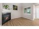 Comfortable living room with a warm fireplace, large windows, and wood-look flooring, great for relaxing! at 12919 W Burgundy Dr, Littleton, CO 80127