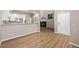 Open-concept living room features fireplace, modern flooring, and adjoins the kitchen for easy entertaining at 12919 W Burgundy Dr, Littleton, CO 80127