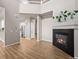 Spacious living room with modern fireplace, high ceilings, and hardwood floors offers warmth and style at 12919 W Burgundy Dr, Littleton, CO 80127