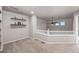 Cozy loft area with shelving, ceiling fan, and natural light; ideal for a reading nook or home office at 12919 W Burgundy Dr, Littleton, CO 80127