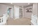 Versatile loft space featuring neutral paint, built-in shelving, and access to additional rooms; perfect for study at 12919 W Burgundy Dr, Littleton, CO 80127