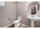 Well-maintained powder room features a pedestal sink, modern fixtures, and neutral paint; simple and clean at 12919 W Burgundy Dr, Littleton, CO 80127