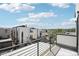 Enjoy city views from this home's private balcony with modern railings and bright, tiled flooring at 1286 Raleigh St, Denver, CO 80204
