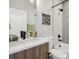 Bathroom features a modern vanity with sleek fixtures and a shower with tiled walls at 1286 Raleigh St, Denver, CO 80204